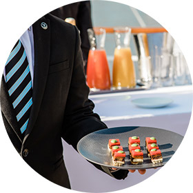 Waiter holding petit fours during a hospitality reception