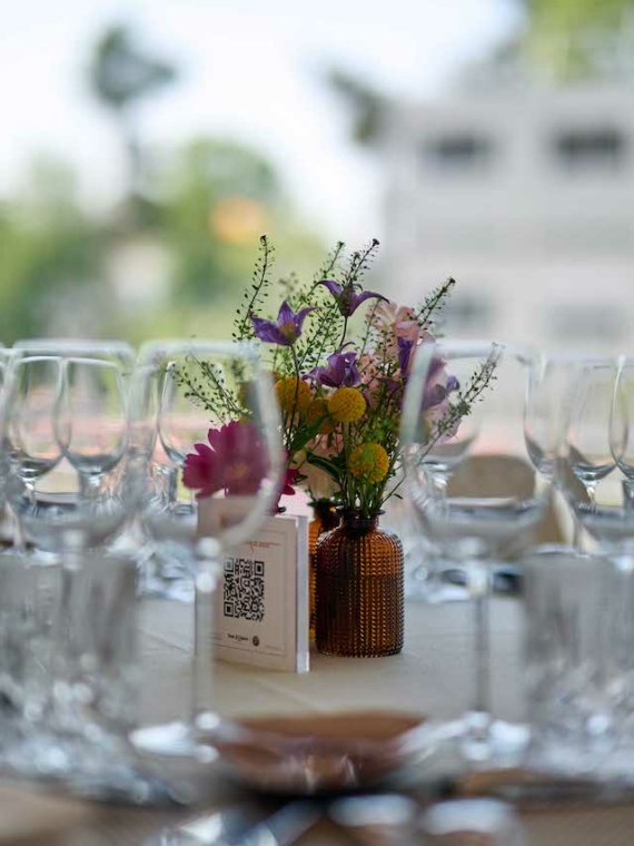 Focus on a beautiful table set in the Salon Legende at Roland-Garros with wine glasses and flower decoration