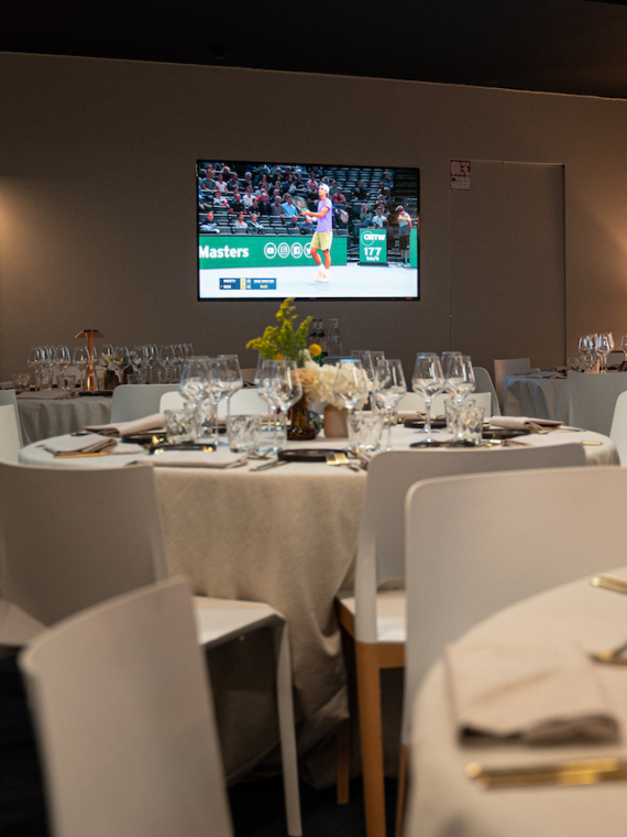 VIP hospitality tables and the screen of the Rolex Paris Masters Lounge & Master Club