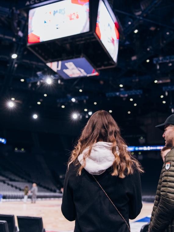 Two people acccessing the game floor before the game