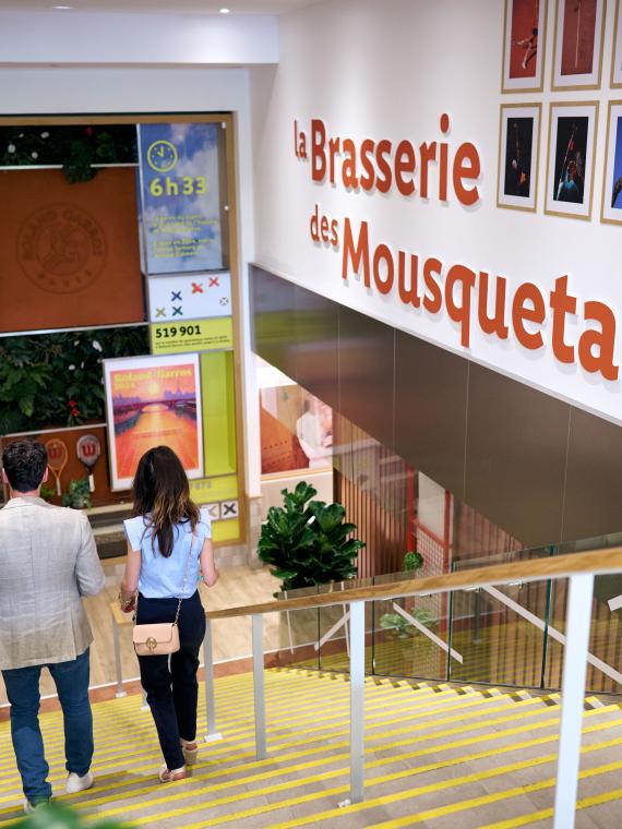 Two guest entering the VIP area at Roland-Garros Mousquetaires lounge