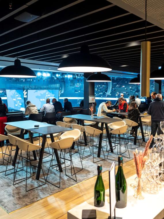 Tables in the premium lounge Les Terrasses, offering an elegant and exclusive setting for events