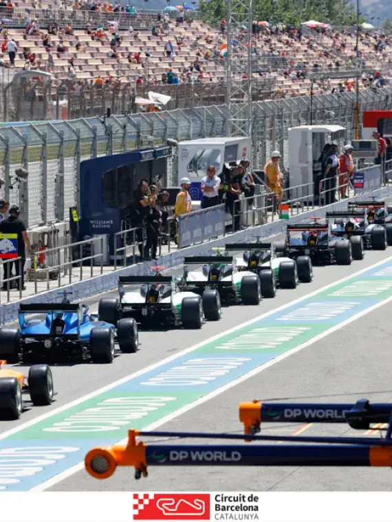 Exclusive VIP view from the pit lane at the Formula 1 Barcelona Grand Prix, showcasing the race cars, team activity, and high-energy atmosphere.