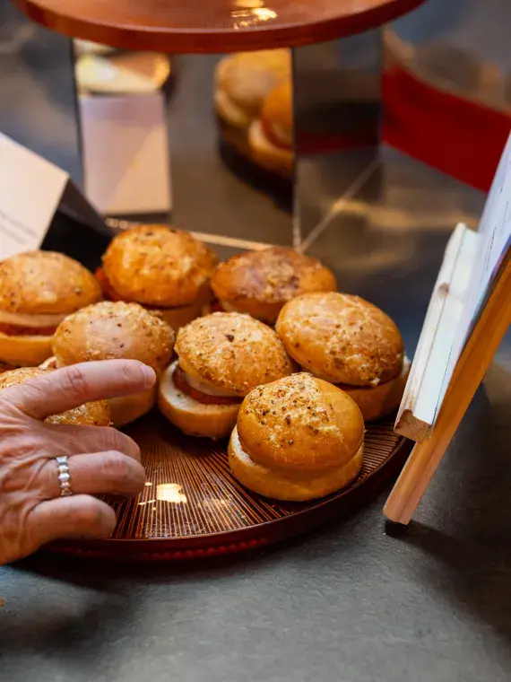 Tray of mini burgers ready to be served to guests, part of the sweet and savory buffet offerings by Sodexo Live! Hospitality.
