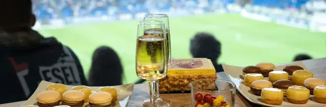High-end hospitality experience with live cooking stations overlooking the pitch