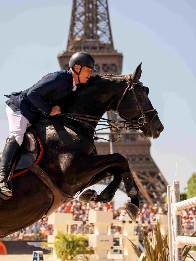 Cavalier en action sautant un obstacle lors du Longines Paris Eiffel Jumping.