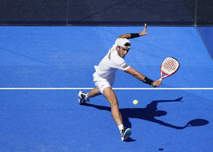 Padel player performing a powerful backhand shot during a match at the Alpine Paris Major Padel 2026, as part of the Sodexo Live! Hospitality experience in Paris.