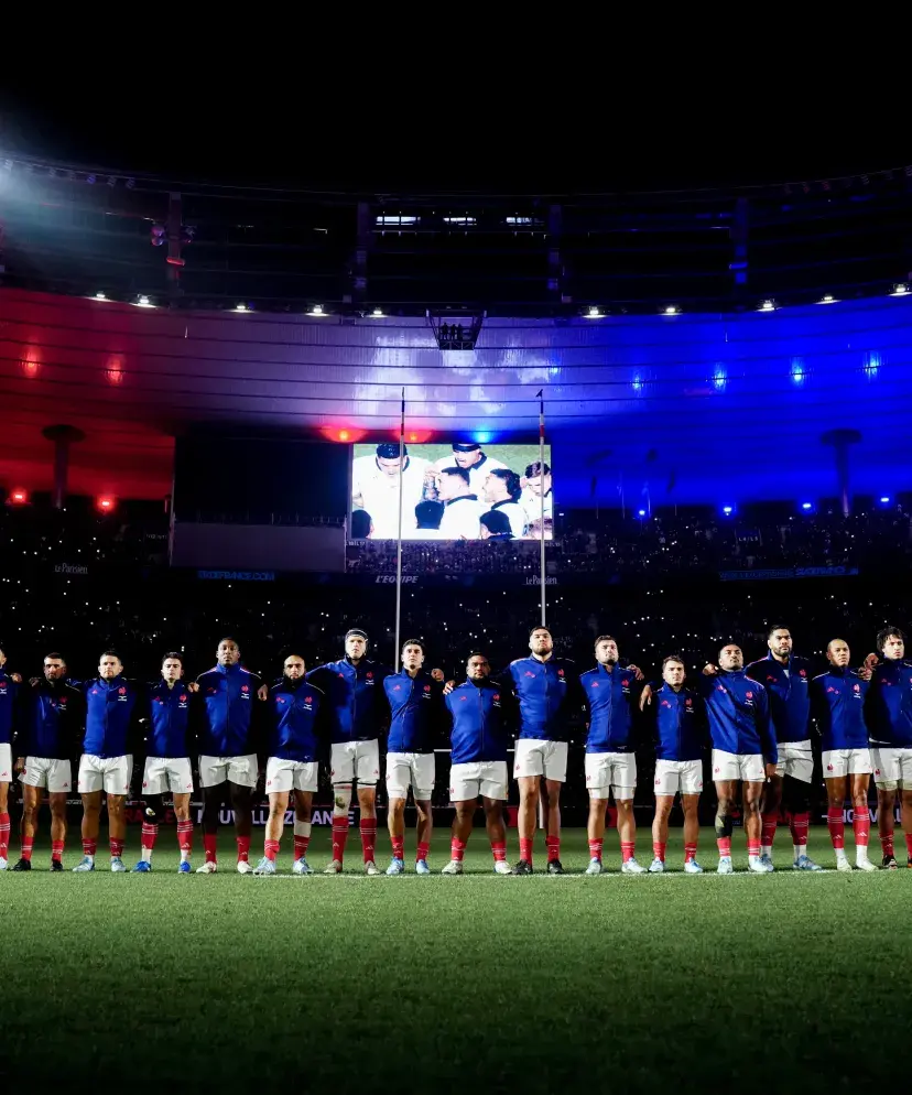View of the French national rugby team lined up on the Stade de France pitch during the national anthem, before a November test match.